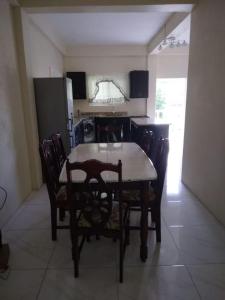 a dining room table and chairs in a kitchen at Ark Royal of the Caribbean in Kingstown