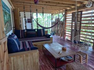 a living room with a couch and a table at P'tites chambres dans la campagne de Marie Galante in Grand-Bourg