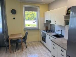 a small kitchen with a table and a window at Apartament COMFORT Centrum in Krotoszyn
