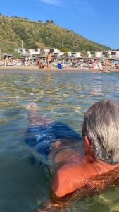 a person swimming in the water in the ocean at Ancora Resort in Acciaroli