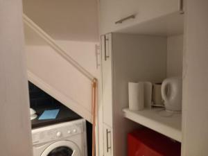 a small kitchen with a washing machine and a staircase at Cosy 1 Bedroom Flat-Newport (F2) in Newport