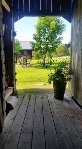 an open door of a barn with a potted plant at Søberget in Stange