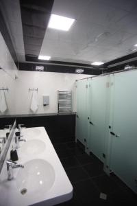 a bathroom with two sinks and a shower and stalls at Hostello in Baku