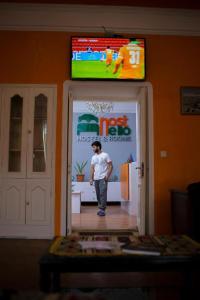 a man standing in the doorway of a store at Hostello in Baku