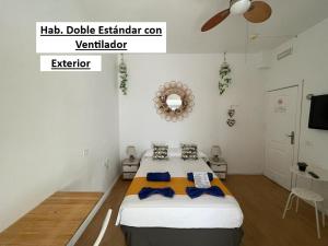 a bedroom with a bed with a ceiling fan at El Sueño De Alejandra - Apartments in Las Palmas de Gran Canaria