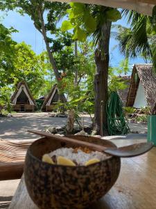 a bowl of food sitting on top of a table at Georgia's Neverland Hostel in Malapascua Island