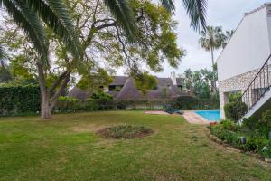 a yard with a swimming pool and a house at Casa Teresa in Marbella