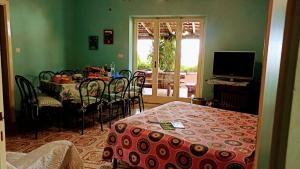 a room with a table and a dining room at The Secret Garden Maratea - Casa di Sery in Maratea