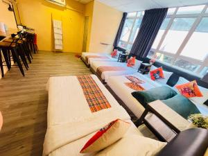 a room with a bunch of beds in a room at Loft Pals Urbanstay Lodge, Kapit in Kapit