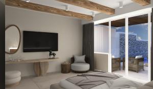 a living room with a television and a bedroom at Alexandra Golden Boutique Hotel-Adults Only in Chrysi Ammoudia