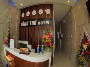 a hotel lobby with clocks on the wall at Hùng Thư Motel in Da Nang