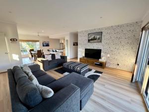 a living room with a couch and a tv at The Four CCCC's in Robe