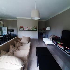 uma sala de estar com um sofá e uma mesa em Huize tinke em Tongeren