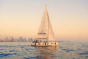 a group of people on a sail boat in the water at Carlton Tel Aviv Hotel – Luxury on the Beach in Tel Aviv