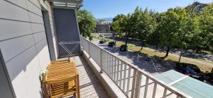 a balcony with two chairs and a swimming pool at Daisy apartment in Ajdovščina