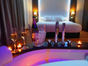 a bathroom with a tub and a bed with candles at MB Boutique Hotel - Adults Recommended in Nerja