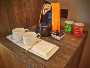 a table with two cups and a plate of food at MB Boutique Hotel - Adults Recommended in Nerja