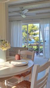 Una sala de estar con mesa y sillas y un comedor. en Nama Beach House, en rkadiko Chorio