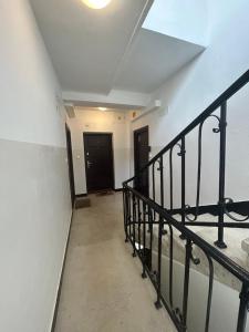 an empty hallway with a staircase and a black door at La Mia Casa STARE MIASTO Warszawa in Warsaw