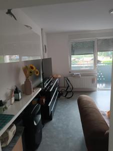 a living room with a couch and a desk at Apartma pri Renati in Celje +6 photos