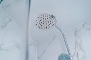 a shower with a shower head in a shower at Luxurious Living 2 BR Home MCR in Manchester