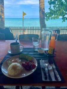 une assiette de nourriture sur une table avec vue sur l'océan dans l'établissement Treasure Beach Resort, à Carles