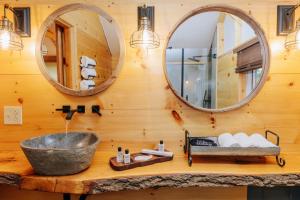 a bathroom with a sink and two mirrors at The Preserve Battenkill River in Cambridge