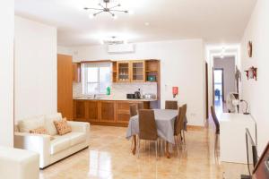 a living room and kitchen with a table and a couch at Gudja - Lovely 3 bedroom unit with own private entrance in Gudja +26 photos