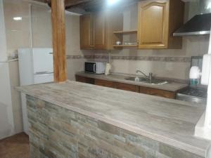 a kitchen with a white refrigerator and a sink at Casa de pueblo García Marquez in Geldo