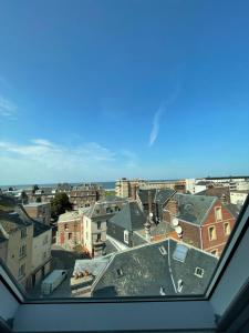 a view of a city from a window at LA TOUR AUX CRABES près de la plage in Dieppe