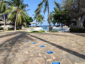 a resort with palm trees and a swimming pool at Sophia house in Malindi