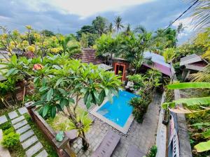 an aerial view of a house with a swimming pool at Uma Dewa homestay in Keramas