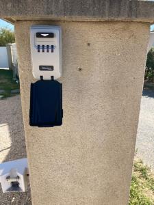 a pay meter in a stone box on a street at Chez Val et Phil in La Voulte-sur-Rhône