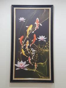 a framed painting of birds on a branch with flowers at Palmy House Homestay Udonthani in Udon Thani