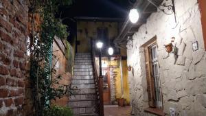 an alley with stairs in an old building at night at Villa Escondida in Mar del Plata