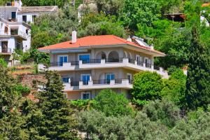 a house on the side of a hill with trees at Endless green 1 Arethousa Ikaria in Arethousa