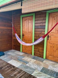 a hammock hanging from the outside of a cabin at Casamango in Basse-Terre