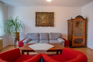 a living room with a couch and red chairs at Penzion Eva Krnov in Krnov