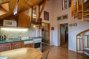 a kitchen with a table and a stove top oven at Penzion Eva Krnov in Krnov