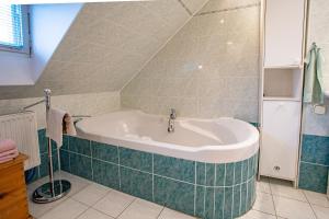 a bathroom with a bath tub in a room at Penzion Eva Krnov in Krnov
