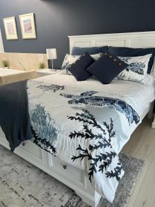 a white bed with a black and white comforter at Beachside Villa 7.1 in Mandurah