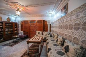a living room with a couch and a table at Riad Fez Hostel in Fès