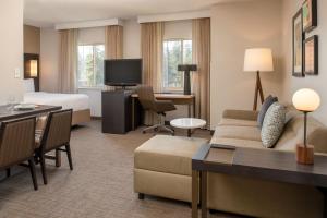 a hotel room with a couch and a bed and a desk at Residence Inn Seattle East/Redmond in Redmond