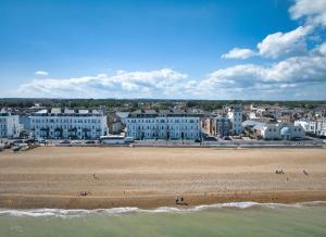 a view of a beach with buildings and the ocean at Stylish beachfront apartment in historic Deal in Kent