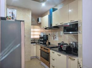 a kitchen with a stainless steel refrigerator and appliances at BBAN-Luxurious 4 Bedroom House in Lekki Ajah Lagos in Lekki