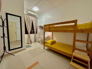 a bedroom with a bunk bed and a mirror at Homestay Mijanna in Johor Bahru