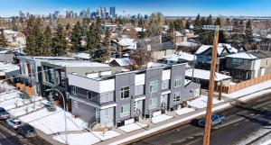 an aerial view of a building with a city in the background at Modern Altadore Home 3 Br Fireplace Sleeps 8 in Calgary
