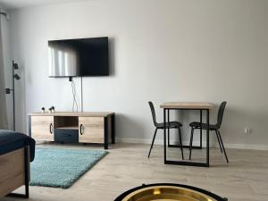 Telewizja i/lub zestaw kina domowego w obiekcie Harmonia Apartments