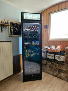 a refrigerator full of drinks in a room at Pension Zur Kutscherstube in Colditz