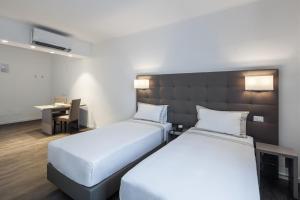 Posteľ alebo postele v izbe v ubytovaní Hotel Studio Inn Centrale & Milano Urban Padel